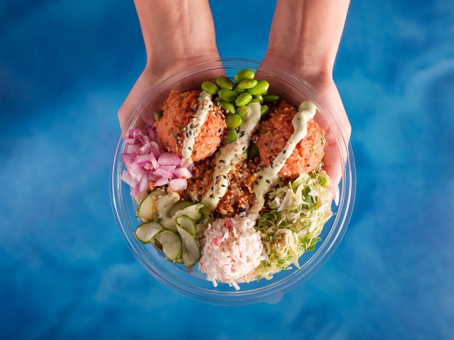 hands holding build your own poke bowl